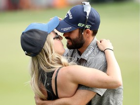 Adam Hadwin of Canada celebrates with fiancee Jessica Dawn on the 18th green after winning the Valspar Championship during the final round at Innisbrook Resort Copperhead Course on Sunday in Palm Harbor, Fla.
