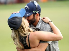 Abbotsford’s Adam Hadwin and his fiancee, Jessica Kippenberger, embrace on the 18th green after Hadwin won the Valspar Championship — his first PGA Tour title — in Palm Harbor, Fla., on Sunday.