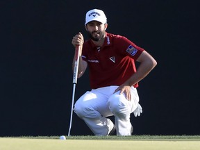Adam Hadwin, of Canada, reads a putt on the 1st hole during the third round of the Valspar Championship golf tournament Saturday, March 11, 2017, at Innisbrook in Palm Harbor, Fla.