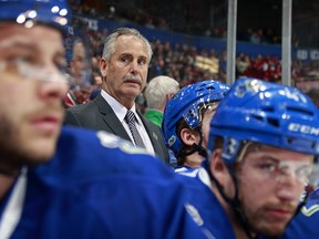 Willie Desjardins looks on from the Canucks' bench against the Canadiens.