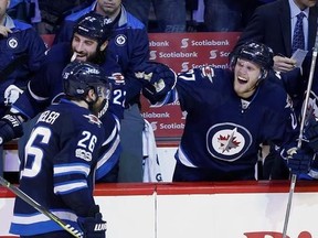 Winnipeg Jets&#039; Blake Wheeler (26), Chris Thorburn (22) and Nikolaj Ehlers (27) celebrate after Wheeler scored the game-winning goal during third period NHL action against the Nashville Predators, in Winnipeg on Saturday, April 8, 2017. Winnipeg Jets players cleaned out their lockers Sunday and left the rink with a collective optimism that the future looks bright, even though the NHL club missed the playoffs for the fifth time in six seasons. THE CANADIAN PRESS/John Woods