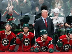 FILE - In this Feb. 18, 2017 file photo Minnesota Wild head coach Bruce Boudreau watches his NHL hockey team play against the Nashville Predators in St. Paul, Minn. Boudreau is back in the playoffs with a third team, the Minnesota Wild in his debut season. For the eighth time in this unique character of a coach&#039;s nine postseason appearances, his team has one of the top two records in its conference. (AP Photo/Jim Mone,File)