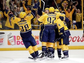 Nashville Predators players celebrate after Roman Josi scored a goal against the Chicago Blackhawks during the second period in Game 4 of a first-round NHL hockey playoff series Thursday, April 20, 2017, in Nashville, Tenn. (AP Photo/Mark Humphrey)