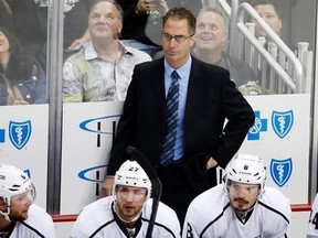 FILE - In this Thursday, Oct. 30, 2014, file photo, Los Angeles Kings assistant coach John Stevens stands behind his bench during the first period of an NHL hockey game against the Pittsburgh Penguins in Pittsburgh. A person with direct knowledge of the situation tells The Associated Press that the Los Angeles Kings will name Stevens their next head coach. Stevens replaces Darryl Sutter after serving as a Kings assistant and then associate coach for the past eight seasons, which included two Sta