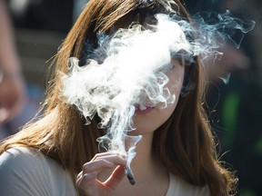 A girl smokes a joint at the 4/20 event in downtown Vancouver in April 2015.