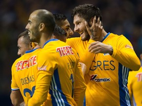 Tigres' Andre-Pierre Gignac, right, celebrates with teammates after scoring during second half, second leg, CONCACAF Champions League soccer semifinal action against the Vancouver Whitecaps, in Vancouver, B.C., on Wednesday, April 5, 2017.