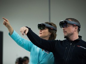 Liberal Leader Christy Clark, left, and Finger Food Studios CEO Ryan Peterson wear Microsoft HoloLens devices during a campaign stop at the company in Port Coquitlam on Wednesday.