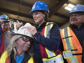 Liberal leader Christy Clark signs a workers helmet as she makes a campaign stop at Inland Concrete in Fort St. John, B.C., Tuesday, April 18, 2017.