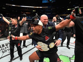 Daniel Cormier celebrates his rear choke submission victory over Anthony Johnson in their UFC light heavyweight championship bout during the UFC 210 event at KeyBank Center on Saturday in Buffalo, New York.