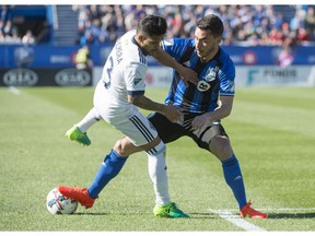 Vancouver Whitecaps midfielder Cristian Techera and Montreal Impact defender Daniel Lovitz battle for the ball on Saturday in Montreal.