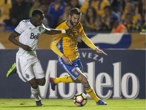 Andre Pierre Gignac of Mexico's Tigres, right, battles for the ball with Alphonso Davies of the Vancouver Whitecaps during their CONCACAF Champions League first leg semifinal match in Monterrey, Mexico on March 14, 2017.