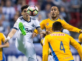 Vancouver Whitecaps' Fredy Montero, back left, and Tigres' Guido Pizarro vie for the ball during first half, second leg, CONCACAF Champions League soccer semifinal action two weeks ago.