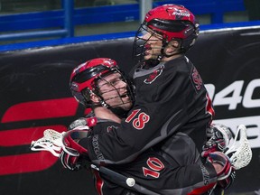 Vancouver Stealth teammates Rhys Duch  and Logan Schuss celebrate Duch's goal on the Colorado Mammoth Saturday at the Langley Events Centre.