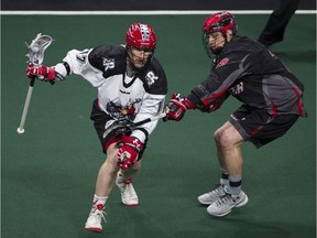 Vancouver Stealth defender Justin Salt (right) pressures Calgary Roughnecks sniper Curtis Dickson during a January regular season NLL game at the Langley Events Centre. The teams square off again there on Saturday.