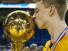 Kelowna Owls Grant Shephard kisses the MVP trophy after being named tournament Most Valuable Player at the 2016 Boys Quad A High School Basketball Championships at the Langley Events Centre on March 12.