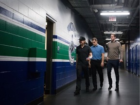 Vancouver Canucks' Markus Granlund, left, Bo Horvat and goalie Jacob Markstrom, of Sweden, arrive for an end of season news conference earlier this month. The three players represent the Canucks' future, one that includes embracing the full rebuild.