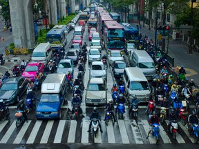 Motorcyclists demonstrate lane-splitting at Bangkok in 2010.