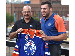 Edmonton Oilers general manager Peter Chiarelli poses with free agent forward Milan Lucic last summer.