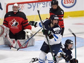Finland's Noora Tulus (24) and Emma Nuutinen (22) celebrate the winning goal scored on Canada goaltender Emerance Maschmeyer (30) in the IIHF Ice Hockey Women's World Championship preliminary round game in Plymouth, Mich., on Saturday, April 1, 2017.