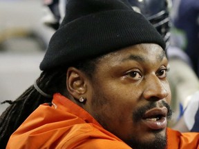 FILE - In this Dec. 4, 2016, file photo, retired Seattle Seahawks running back Marshawn Lynch, left, chats on the sidelines players on the bench in the second half of an NFL football game against the Carolina Panthers in Seattle. A person familiar with the deal tells The Associated Press that the Oakland Raiders have agreed to a two-year contract to bring running back Marshawn Lynch out of retirement. The person says the sides have agreed on the terms pending a physical for Lynch on Wednesday, April 26, 2017. The person spoke to the AP on condition of anonymity because the contract has not been finalized.  (AP Photo/Ted S. Warren, File)