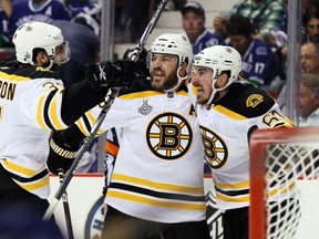 Patrice Bergeron, Mark Recchi and Brad Marchand of the Bruins celebrate after opening scoring in Game 7 of the 2011 Stanley Cup final.