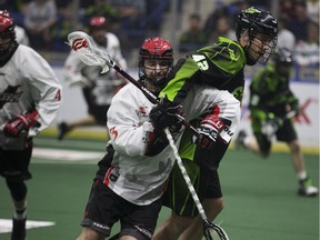 Saskatchewan Rush forward Mark Matthews (right) runs interference on Vancouver Stealth defender Matt Beers during a January National Lacrosse League game at the SaskTel Centre in Saskatoon.