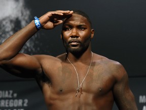 LAS VEGAS, NV - AUGUST 19:  Mixed martial artist Anthony Johnson salutes as he poses on the scale during his weigh-in for UFC 202 at MGM Grand Conference Center on August 19, 2016 in Las Vegas, Nevada. Johnson will meet Glover Teixeira in a light heavyweight bout on August 20, 2016, at T-Mobile Arena in Las Vegas.  (Photo by Ethan Miller/Getty Images)