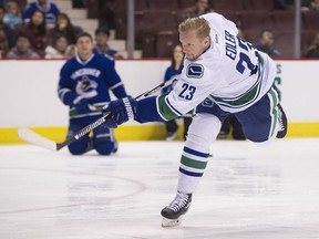 Columnist Ed Willes believes the Vancouver Canucks either need to squeeze out defenceman Alex Edler, left, or reduce his ice time if the NHL team's rebuild process is going to be successful.