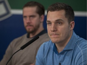 Bo Horvat, right, and Jacob Markstrom face the media at Rogers Arena in Vancouver on Tuesday.