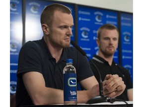 Vancouver Canucks players face the media at Rogers Arena Tuesday, April 11, 2017. Pictured is (from left to right) Henrik Sedin and Daniel Sedin.