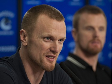 Vancouver, BC: April 11, 2017 -- Vancouver Canucks players face the media at Rogers Arena Tuesday, April 11, 2017. Pictured is (from left to right) Henrik Sedin and Daniel Sedin.