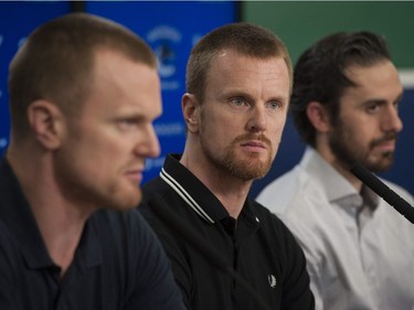 Vancouver, BC: April 11, 2017 -- Vancouver Canucks players face the media at Rogers Arena Tuesday, April 11, 2017. Pictured is (from left to right) Henrik Sedin, Daniel Sedin and Ryan Miller.