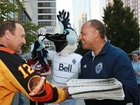 Carl Valentine always brings a smile to people's faces. Here he is with ex-Canuck Stan Smyl in 2012.