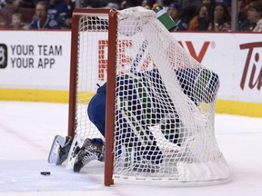 Vancouver Canucks defenceman Erik Gudbranson crashes into the net trying to stop an own goal from Loui Eriksson during the Canucks' home opener against the Calgary Flames in October. It was an inauspicious start for the team, and the season went downhill from there.