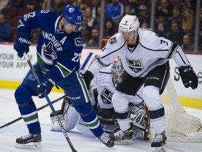 Daniel Sedin digs for the puck in front of LA Kings defenceman Brayden McNabb in the first period of a regular season NHL hockey game last March at Rogers Arena.