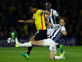 Troy Deeney of Watford battles through West Bromwich Albion to score his team’s second goal during Tuesday’s Premier League match at Vicarage Road in Watford, England.