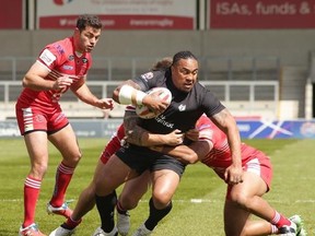 Toronto Wolfpack forward Fuifui Moimoi tries to break through a pair of tacklers in Toronto‚Äôs 29-22 loss to the Salford Red Devils on April 23, 2017 in Salford, England, in the fifth round of the Ladbrokes Challenge Cup. The Wolfpack make their league debut Saturday in Toronto.THE CANADIAN PRESS/Toronto Wolfpack MANDATORY CREDIT