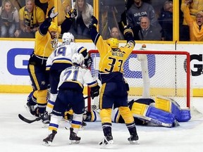 Nashville Predators center Mike Fisher, left, and left wing Colin Wilson (33) celebrate after teammate Ryan Ellis, not seen, scored a goal against St. Louis Blues goalie Jake Allen during the third period in Game 4 of a second-round NHL hockey playoff series Tuesday, May 2, 2017, in Nashville, Tenn. The Predators won 2-1 to take a 3-1 lead in the series. (AP Photo/Mark Humphrey)