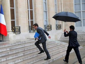 FILE - In this file photo dated Tuesday, May 10, 2016, French Economy Minister Emmanuel Macron, centre, runs up the steps ahead of an emergency cabinet meeting at the Elysee Palace, in Paris, after the French government decided to use special powers to pass a hotly contested labor reform without vote at lower house of parliament. The former outsider with little political experience, Macron is now considered the front-runner for the second round of France&#039;s Sunday May 7 2017, presidential electio