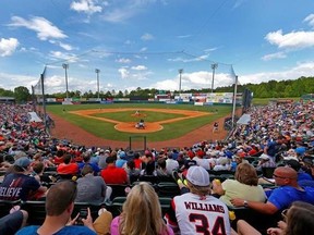 In this April 30, 2017 photo, fans packed the grandstands to get a chance to watch the Hickory Crawdads host the Columbus Fireflies and Tim Tebow in a minor league baseball game at L.P. Frans Stadium in Hickory, N.C. The Single A teams of the South Atlantic League are seeing a burst in attendance whenever Tebow and the Columbia Fireflies go on the road. (Ernie Masche/The Hickory Daily Record via AP)