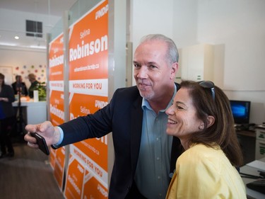 NDP Leader John Horgan, left, takes a selfie with local candidate Selina Robinson during a campaign stop in Coquitlam, B.C., on Sunday May 7, 2017. A provincial election will be held on Tuesday.