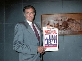 FILE - In this June 12, 1991, file photo, Frank Deford, editor and publisher of The National Sports Daily, holds a proof of the final front page of the newspaper after a news conference at the paper&#039;s offices in New York. Award-winning sports writer and commentator Frank Deford has died. He was 78. Deford passed away Sunday, May 28, 2017, in Key West, Florida, his family confirmed. (AP Photo/Susan Ragan, File)