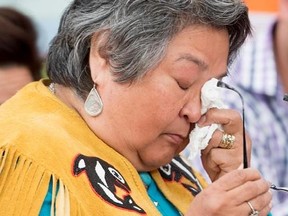 Francais Neumann wipes a tear away as she tells a story about her murdered sister- in-law Mary Johns at the National Inquiry into Missing and Murdered Indigenous Women and Girls taking place in Whitehorse, Yukon, Tuesday, May 30, 2017. THE CANADIAN PRESS/Jonathan Hayward