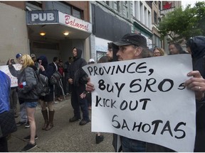 Protesters gather outside the Balmoral Hotel on East Hastings Street in Vancouver on May 30 to vent against the living conditions of the tenants.