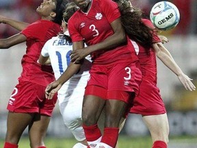Ashley Lawrence, left, Kadeisha Buchanan, cente, Allysha Chapman, right, of Canada jump for the ball with Fara Williams of England during the Cyprus Women&#039;s Cup soccer final match in Nicosia on March 11, 2015. Wingback Ashley Lawrence and defender Kadeisha Buchanan, both 21, face off in an all-French final of the UEFA Women&#039;s Champions League in Cardiff, with Lawrence wearing Paris Saint-Germain colours and Buchanan representing defending champion Lyon. THE CANADIAN PRESS/AP, Petros Karadjias