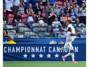Vancouver Whitecaps' Alphonso Davies, left, and Nicolas Mezquida celebrate Davies' goal against the Montreal Impact during first half semifinal Canadian Championship soccer action in Vancouver, B.C., on Tuesday May 23, 2017.