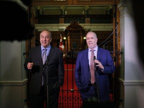 B.C. Green party Leader Andrew Weaver, left, and B.C. NDP Leader John Horgan speak to the media after announcing they'll be working together to help form a government during a news conference at the legislature in Victoria on May 29.