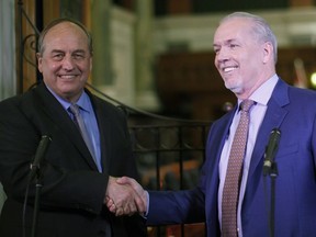 B.C. Green party Leader Andrew Weaver, left, and B.C. NDP Leader John Horgan speak to the media after announcing they'll be working together to help form government during a news conference at the legislature in Victoria.