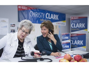 B.C. Liberal leader Christy Clark shares a laugh with a campaign worker as they make phone calls from her campaign headquarters in West Kelowna, B.C., Tuesday, May 9, 2017. The British Columbia election will be held on Tuesday.
