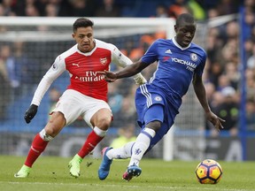 Chelsea's N'Golo Kante, right holds off the challenge of Arsenal's Alexis Sanchez during the English Premier League soccer match between Chelsea and Arsenal at Stamford Bridge stadium in London in February.
